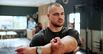 Fitness, gym and man stretching arms for healthy body, wellness or exercise at club. Warm up, training and serious person workout for flexibility, sports or physical activity of athlete with muscle