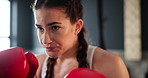 Woman, gym and boxing with training, challenge and practice for a match and sports with endurance. Fighter, person or boxer with workout or girl in wellness centre or progress with health or exercise