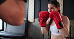 Sports, fitness or boxing with woman and personal trainer at gym for training, practice or spar in preparation for fight. Exercise, health or workout with boxer and coach together for self defense