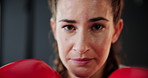 Woman, face and boxing with training, sweating and practice for a match or energy with gloves. Challenge, person or boxer with workout or girl in a wellness centre or progress with health or portrait