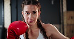 Woman, face and boxing with training, energy and practice for a match and sports with endurance. Challenge, person or boxer with workout or girl in a wellness centre or progress with health or fight