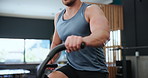 Exercise, spinning and man in gym for training, intense workout and fitness for healthy body. Sports, cardio machine and person on cycling equipment for performance, strong muscles and wellness