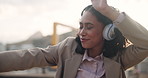 Business woman, headphones and dancing in city with smile, listen and radio in sunshine. Person, dancer and happy in road, sidewalk and music with hearing audio on streaming subscription in Cape Town