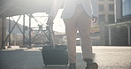 Businessman, suitcase and walking in city for commute, travel or immigration by buildings. Closeup of man or employee in business clothing with luggage for opportunity or outdoor work trip in town