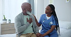 Senior care, nurse and black man with pain in chest with advice, healthcare and exam on bed. Homecare, heart and mature person with caregiver in consultation for medical assessment, support or help.