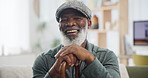 Face, walking stick and and senior black man with disability on sofa in living room of retirement home to relax. Portrait, funny and elderly person laughing in apartment with wooden cane for balance