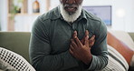 Heart attack, stress and hands of senior man on a sofa with cardiac arrest, emergency or crisis at home closeup. Chest pain, anxiety or old person with breathing problem, panic attack or heartburn