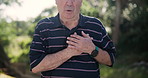 Hands, chest pain and heart attack with old man outdoor, breathing trouble and lungs with angina and disease. Heartburn, asthma and hypertension, medical emergency in park and cardiovascular health