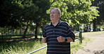 Mature, man and running in park for workout, outdoor and healthy cardio exercise in nature with trees of forest. Fitness, person and runner on path with benefits of wellness in retirement or summer 