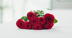 Romance, flowers and roses on bed for love on valentines day, anniversary celebration and honeymoon. Red rose, bouquet and closeup of florals in bedroom for romantic date, occasion and luxury in home