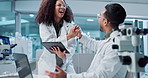 Science, teamwork and high five with laptop in laboratory for test breakthrough, pharmaceutical review or excited. Scientist, collaboration or technology for research, discussion and digital analysis