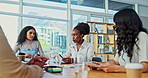 Meeting, teamwork and business women in office for creative collaboration project discussion. Conversation, diversity and group of designers talking, planning and working in workplace boardroom.