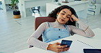 Phone, bored and tired with business woman at desk in office with fatigue or exhaustion from work. Mobile, burnout or social media distraction and frustrated or moody young employee in workplace