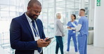 Black man, phone and typing at hospital for communication, social media or healthcare research at hospital. African businessman or visitor on mobile smartphone for online chatting, texting or app