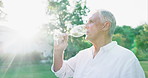 Sunset, drink and man with wine in glass outdoor on farm tasting luxury alcohol in nature. Vineyard, winery and mature person relax on holiday in summer, field and experience rich flavor of liquid