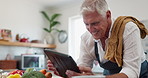 Digital, search and senior man cooking in a kitchen with online recipe, meal prep or vegetable ingredient check.Tablet, app and old male person having fun in retirement with food, blog or brunch