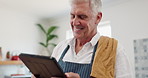 Man, tablet and laughing in kitchen with cooking dinner in apron or healthy nutrition or funny post, connection or humor. Elderly person, chef and home with internet recipe or joy, joke or retirement