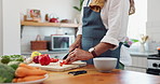 Cooking, hands and man with healthy food for nutrition, meal prep and cutting fresh ingredients for lunch. Diet, vegetables and home chef at kitchen counter with knife, recipe and salad for dinner.