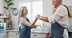 Couple, kitchen and dance with hug, trust and support for communication, celebration and retirement. Senior people, smile and cooking for conversation, love and commitment with holiday or vacation