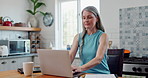 Woman, laptop and typing in kitchen as blogger for food recipe or online connection, research or post. Mature person, email and apartment with coffee for morning work for web, paperwork or breakfast