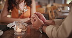 Couple, hand holding and dinner restaurant on date or valentines day celebration, engagement or connection. People, finger and embrace at table or marriage bonding for anniversary, care or commitment