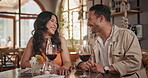 Wine, dating and couple laughing in restaurant together for love, romance or anniversary celebration. Smile, conversation or joking with man and woman at romantic dinner for valentines day date