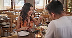 Food, date and couple eating in restaurant together for love, romance or anniversary celebration. Fine dining, smile or conversation with man and woman dating at romantic dinner for valentines day