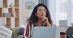 Woman, laptop and thinking in living room for research, planning or online writing career. Female person, freelancer and remote work with technology for ideas, networking and communication in home