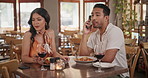 Couple, angry and restaurant with phone for communication and conversation with food. Frustrated woman, man and toxic relationship with smartphone on moody valentines day date, speaking or talking