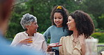 Grandmother, mother and daughter at lunch in garden with conversation, happy and reunion with love. Women, girl or child in backyard, park and family home with smile for love, care or happy in Mexico