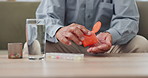 Hands, elderly person and pills on table with water, medicine for health and treatment for sick patient at home. Pharmaceutical drugs, supplements or antibiotics with daily routine for healthcare