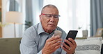 Phone, medicine and senior man with home research, reading label and learning of telehealth services. Online patient with pills bottle, tablet and mobile for information or health benefits on a sofa