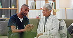 Caregiver, patient and pills, instructions and help for treatment dosage, medicine and elderly care. Pharmaceutical drugs, advice and African nurse with old woman on sofa and supplements for health