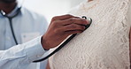 Hand, chest and stethoscope, doctor and patient for healthcare, cardiology and listening to heart at clinic. Medical exam for diagnosis, monitor heartbeat and people in consultation with health
