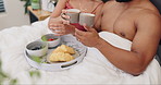 Couple in bed, breakfast and tea with cheers, love and commitment with food, bonding and Valentines day romance. Care, trust and nutrition with people and fruit, croissant and drink in bedroom