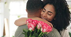 Couple, hug and flowers or smile for valentines day with love or surprise bouquet for relationship, anniversary or date. Man, woman and embrace in home with roses for marriage, celebration or present