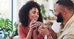 Couple, coffee and smile with toast on sofa in home living room with listening, chat and connection. Woman, man and tea cup with love, happy and bonding in lounge for congratulations in Colombia