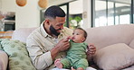 Family, happy and father dance with baby on sofa for bonding, relationship and child development together. Home, parents and dad play with newborn for care, support and affection in living room