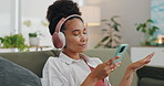 Home, headphones and woman with a smartphone, smile and streaming music in a lounge. Person, apartment and girl with sound or headset with a cellphone or stress relief with connection, radio or happy