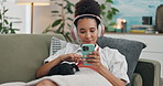 Home, headphones and woman with a smartphone, relax and streaming music in a lounge. Person, apartment and girl with a pet and headset with a cellphone and mobile user with connection, radio or sound