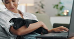 Remote work, laptop and woman with dog on a sofa for comfort while online with client, feedback or communication. Freelance, pets and female consultant in living room with puppy while checking email
