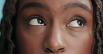 Face, black woman and eye with annoyed attitude in studio on blue background, bored and attitude in disbelief. Serious, rolling eyes and frustrated with disappointment and unhappy mood with doubt. 