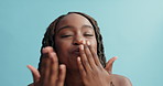 Happy, face and black woman blowing kisses with love for style, fashion or care on a blue studio background. Portrait of African female person or model smile with kiss for perfection on mockup space