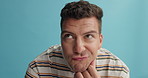 Doubt, thinking and confused man in studio for solution, problem solving or difficult decision on blue background. Why, questions and male model with unsure emoji, guess or memory, asking or clueless