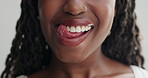 Woman, mouth and lick teeth for dental, health and wellness with cleaning for plaque on white background. Oral hygiene, face zoom and orthodontics, tongue out with veneers and happy for grooming