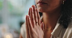 Hands, prayer and woman with faith at her home for worship, religion or spiritual wellness. Gratitude, praying and closeup of female person with christian praise for healing and peace in apartment.