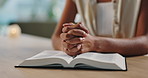 Hands, praying and woman with bible at her home for worship, religion or spiritual wellness. Gratitude, prayer and closeup of female person with holy book for christian faith and peace in apartment.