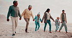 Parents, grandparents and kids at beach with holding hands, talk or adventure for connection on holiday. People, mother and father with children, link and bonding for care for walk by sea on vacation