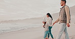 Beach, walking and parents with children for holiday, vacation and adventure in winter. Family, travel and mother, father and kids holding hands for bonding, relationship and relax together by sea