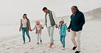 Beach, holding hands and family with children in nature for holiday, vacation and adventure in winter. Grandparents, travel and mother, father and kids for bonding, walking and relax together by sea